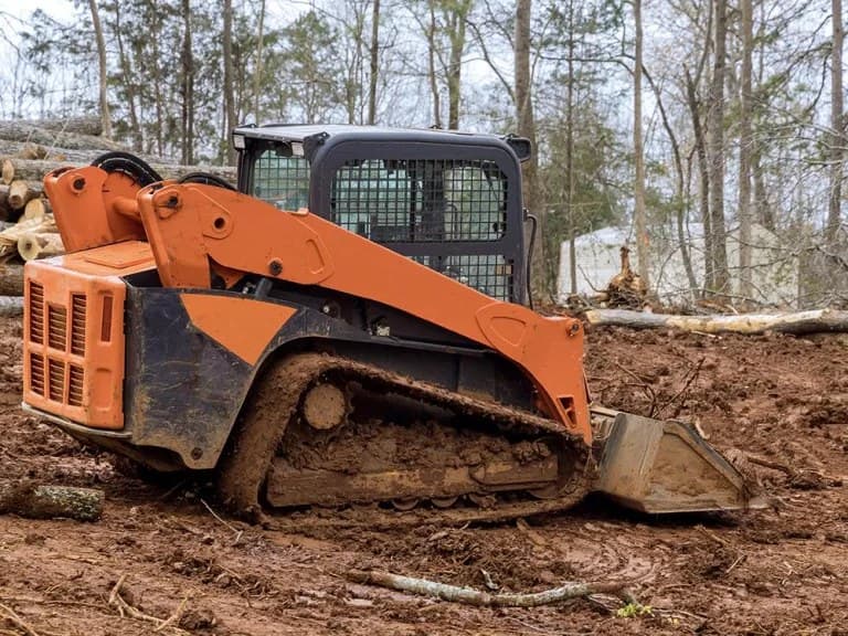 A-1 Land Management's Kubota compact track loader clearing a wooded lot